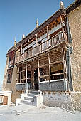 Ladakh - Tikse gompa, the main monastery halls with the characteristc red painted windows and woden balconies